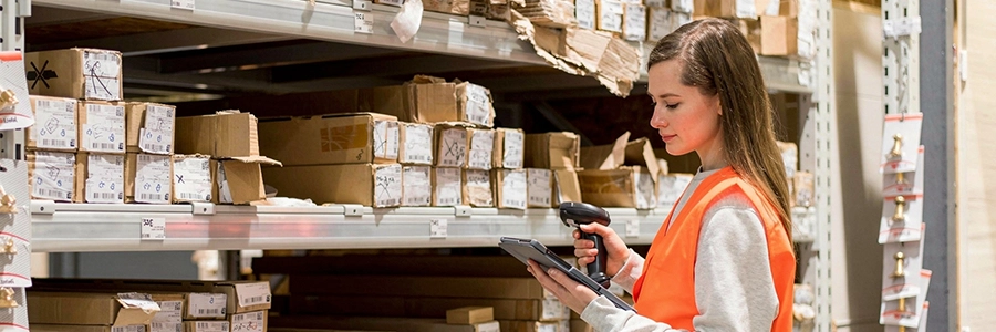 Worker scanning boxes in a warehouse